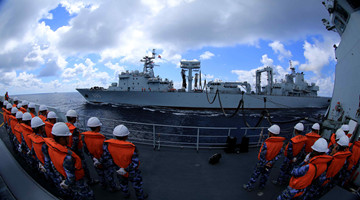 Naval warships perform replenishment-at-sea in Western Pacific
