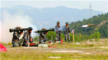 Soldiers fire PF98 120mm anti-tank rocket launcher