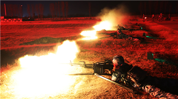 Soldiers fire heavy-machine guns at night