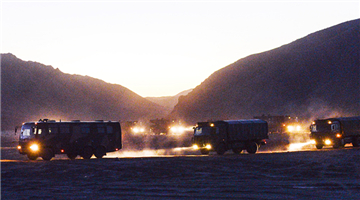 Military vehicles en route to Qilian Mountains