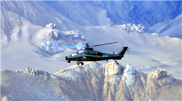 Helicopters fly through valley