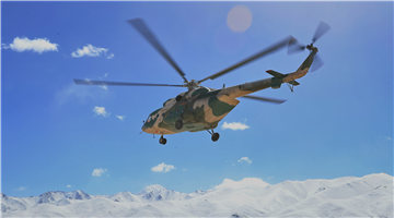 Mi-171 transport helicopters fly over snow-capped mountains