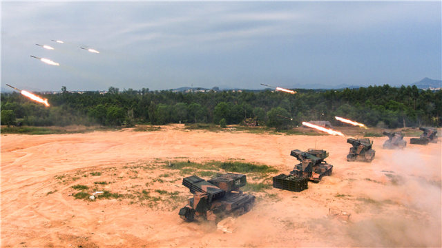 PHZ-89 122mm self-propelled multiple rocket launchers fire at targets