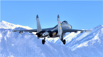 J-11 fighter jets fly over snow-capped mountains