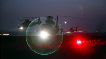 Attack helicopters lift off at night