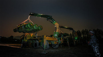 Soldiers load air-defense missile systems at night