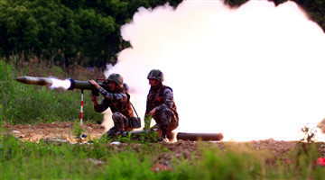 Soldiers fire portable anti-tank rocket launchers