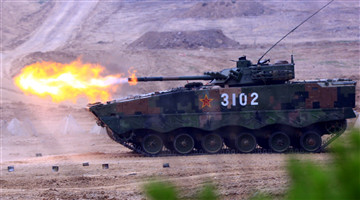 Armored vehicles provide suppressive fires against mock enemies