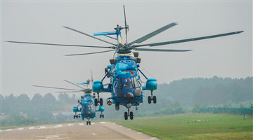 Z-8 transport helicopter flies over brook