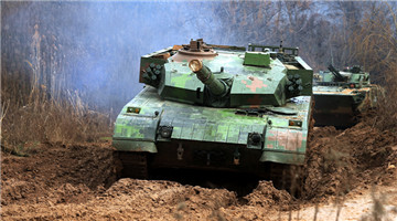 MBTs and IFVs pass through muddy road