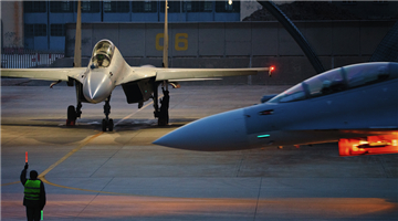 Fighter jets taxi to takeoff line at night