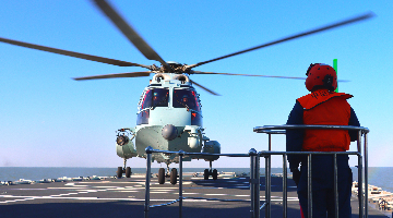 Naval ship-borne chopper lifts off flight deck