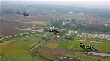 Multi-type helicopters hover over field