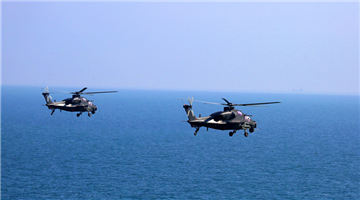 Attack helicopters hover above sea