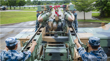 Airmen load missiles onto launching truck