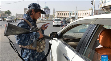 Members of Taliban stand guard at security checkpoint in Kandahar city, Afghanistan