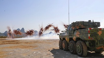 Armored assault vehicles fire smoke bombs