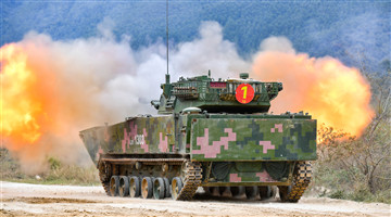 Armored vehicles fire at simulated targets