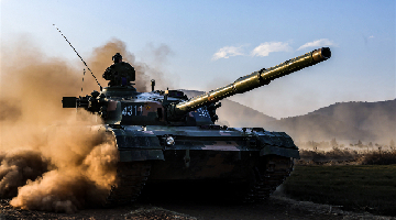 Main battle tank rumbles forward during live-fire exercise