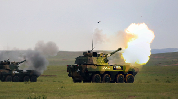Soldiers load anti-tank missiles during combined-arms training