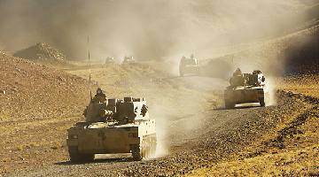 Armored vehicles rumble towards designated area