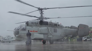 Ship-borne helicopters carry out flight training in rainy days